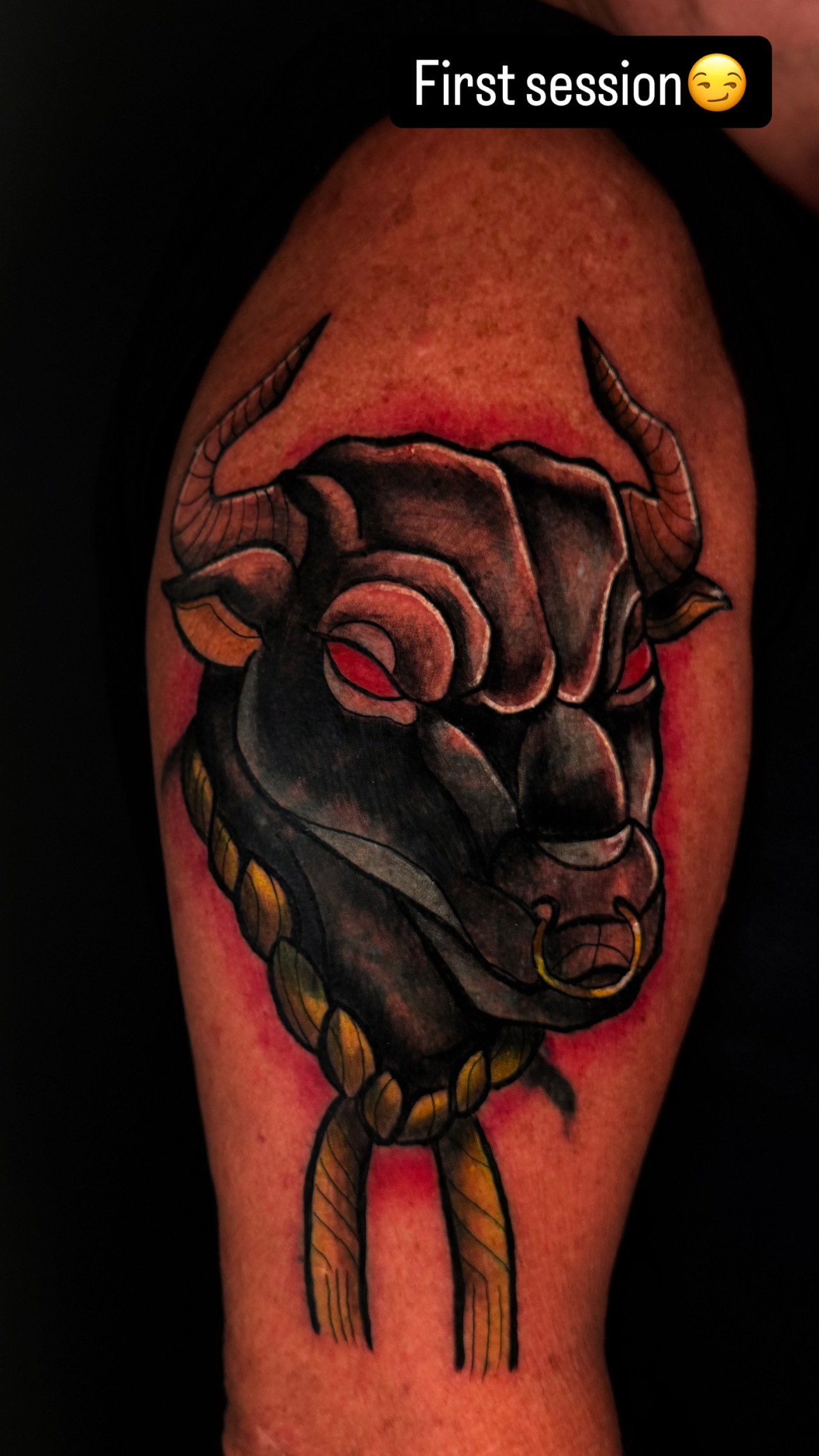 Black and gray bull with red accents tattoo