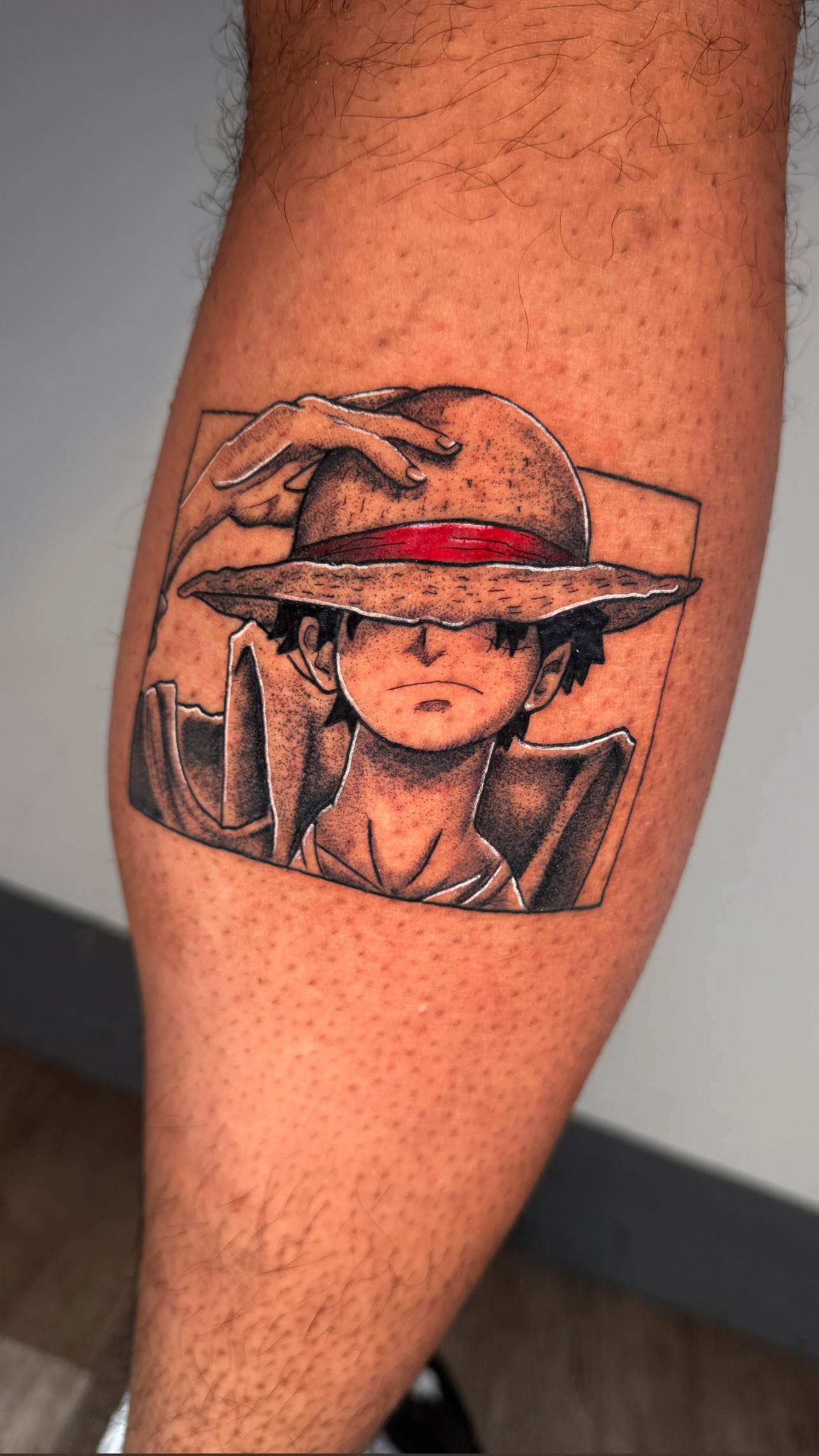 One Piece Luffy character with red hat tattoo