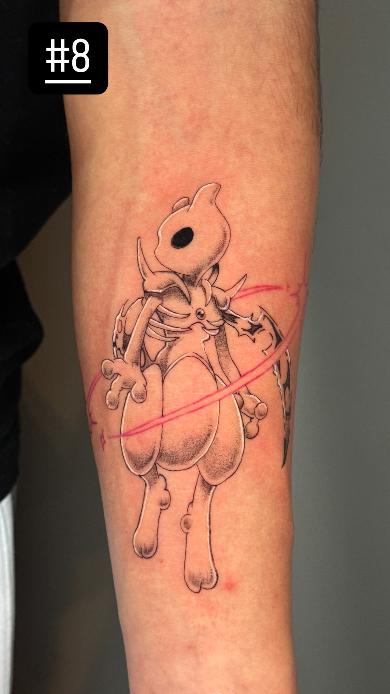 Black and gray Pokémon Cubone tattoo with red accent
