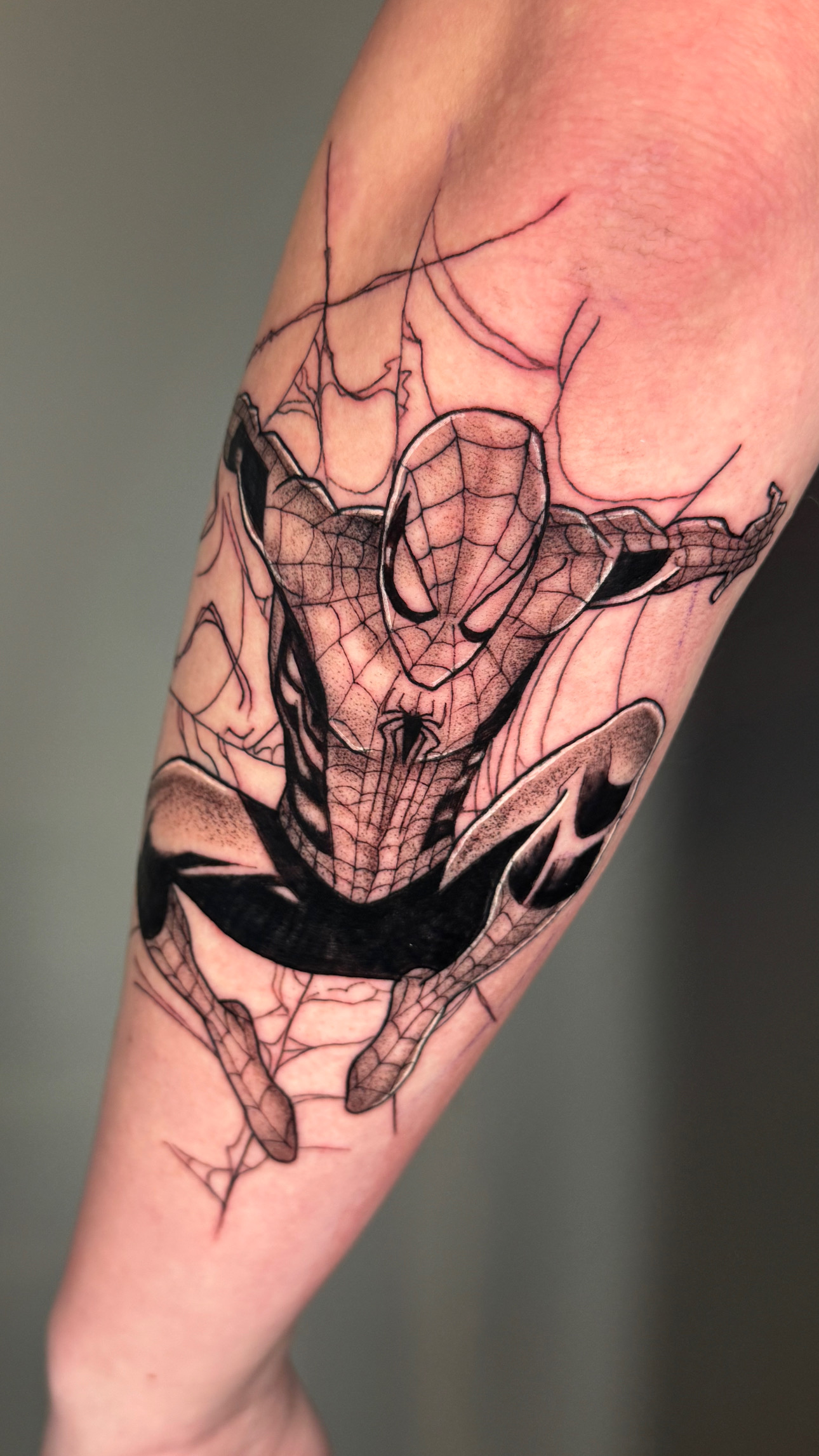Detailed black and gray Spider-Man tattoo